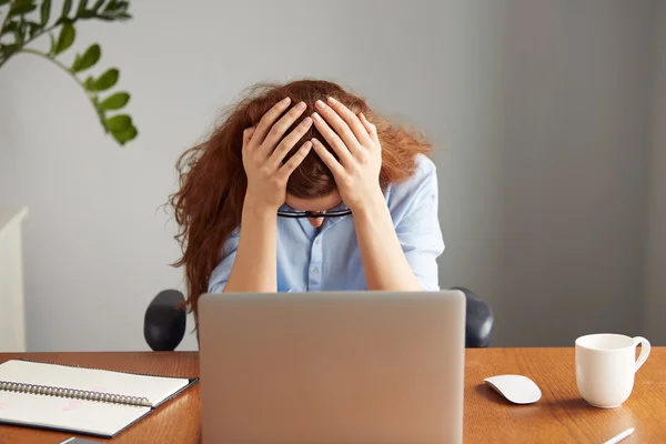 office worker sitting in front of the laptop