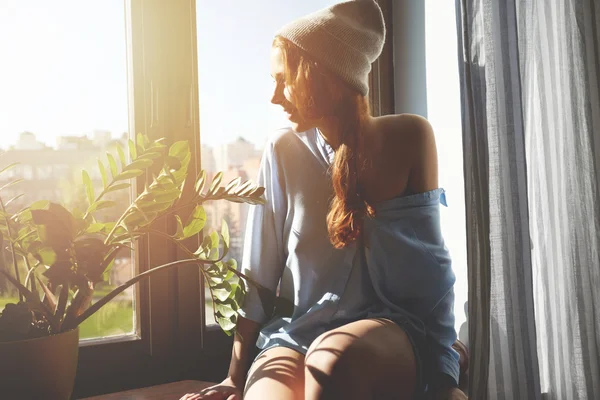 Girl looking through window