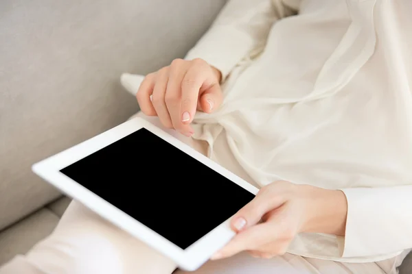 Cropped portrait of female hands holding digital tablet with copy space blank screen for your text or promotional content. Business woman or university student girl browsing internet via touch pad