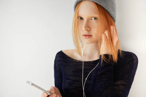 Teenage girl listening to music on cell phone