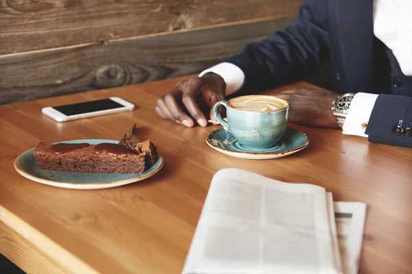 African corporate worker having coffee