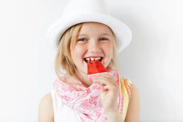 Small European kid biting lollipop