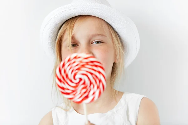 Little blond girl with lollipop