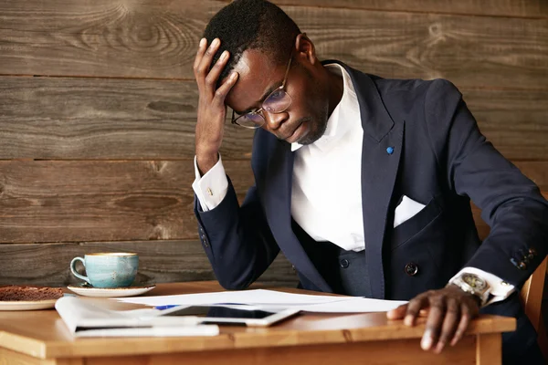 African businessman looking puzzled