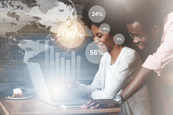 Worldwide connection interface. Double exposure of happy African couple using high-speed Internet on laptop, winning huge money in a lottery, smiling and looking at the screen. Visual effects