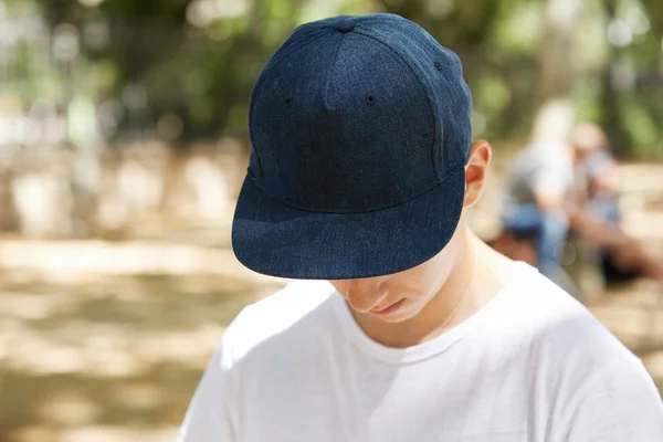 Schoolboy wearing dark blue blank cap