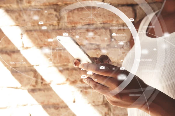 Visual effects. People and technology. Cropped portrait of African woman\'s hands holding a web-enabled touch phone, browsing the Internet, chatting with friends, against brick wall background