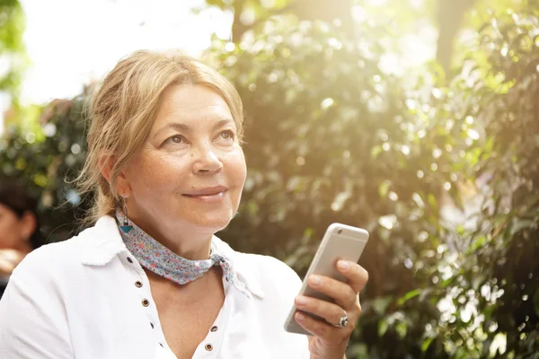 Charming senior woman with smart phone