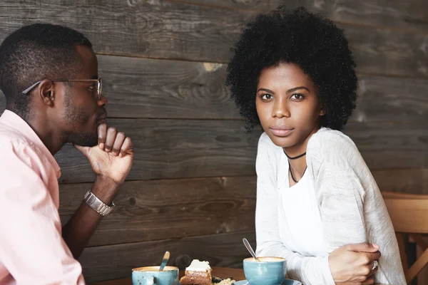 African couple sitting at coffee shop