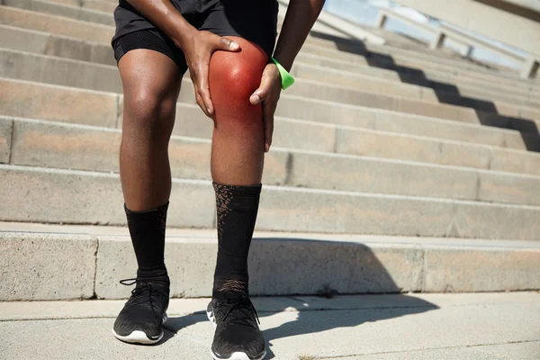 African jogger having knee pain