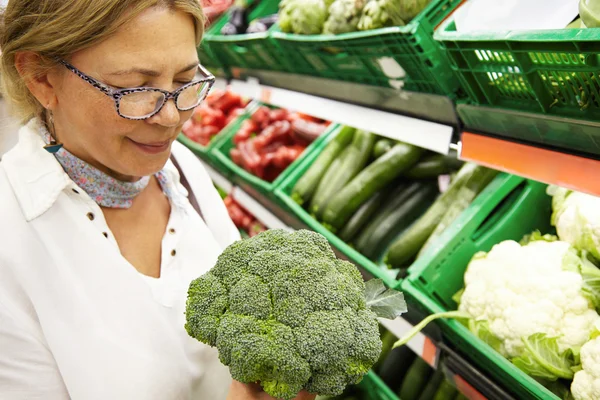 Middle-aged woman holding fresh  broccoli