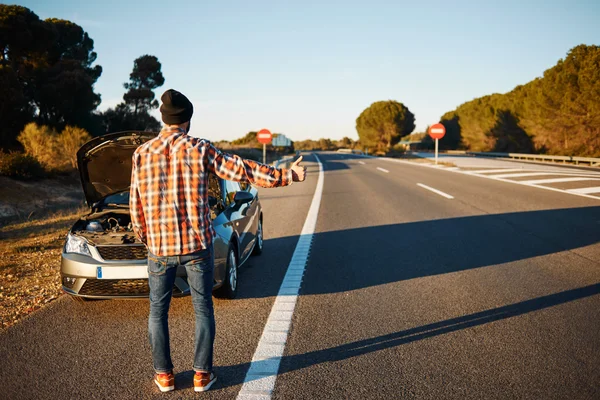 Cars driver trying stop car in travel because his car broken.