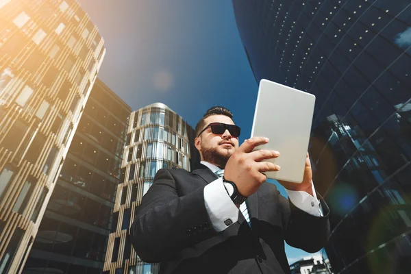 Bottom view portrait of successful business man using touch pad