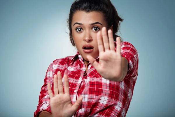 Shocked and frightened woman covering her body in surprsise and disbelief.