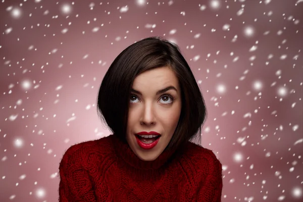 Winter beauty happy smiling woman. Christmas or new year girl concept. Sweet girl in the red sweater standing around snow isolated.