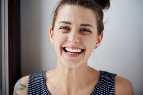 Beautiful model woman with freckles perfect fresh clean skin. Female looking at camera and laughing. Youth and skin care concept. Positive human emotion facial expression body language.