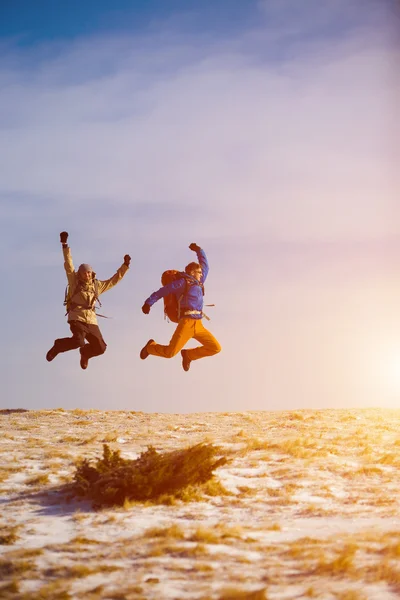 Climbers jumping for joy.