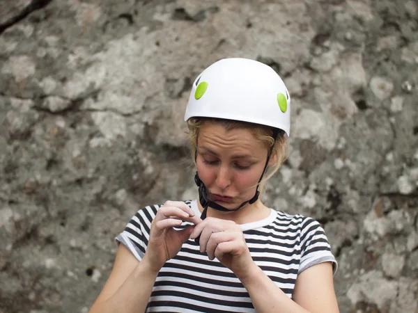 The girl wears a helmet for the best protection.