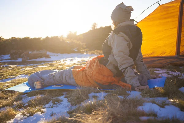 Girl sitting in a sleeping bag.