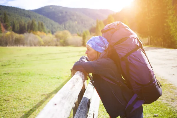 The girl with the backpack resting.