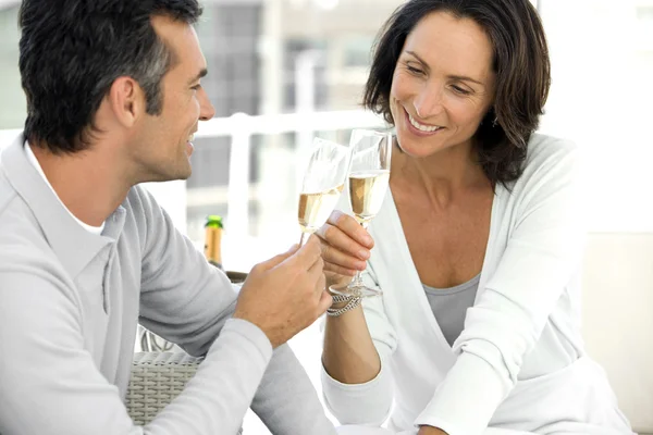 Middle-aged couple in love drinking Champagne