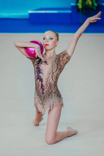 Individual performance girl gymnast exercises with ball
