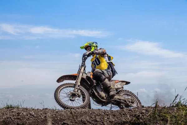 Male rider on a motorcycle on top of a mountain