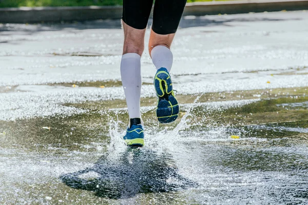 Splashes of water feet male athlete