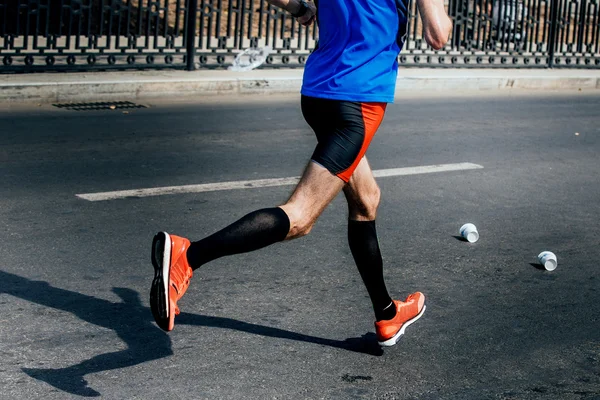 Side view of legs of male athlete in compression socks