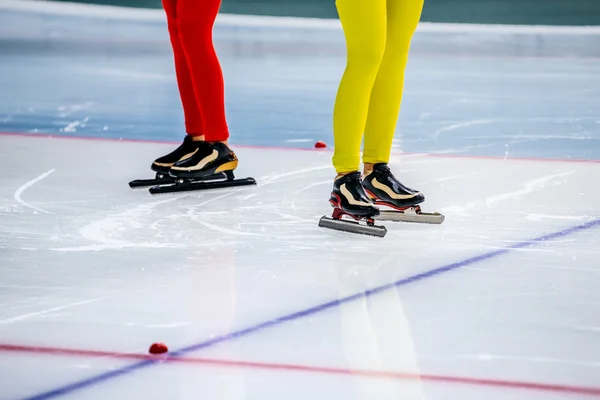 Legs of two girls speed skaters