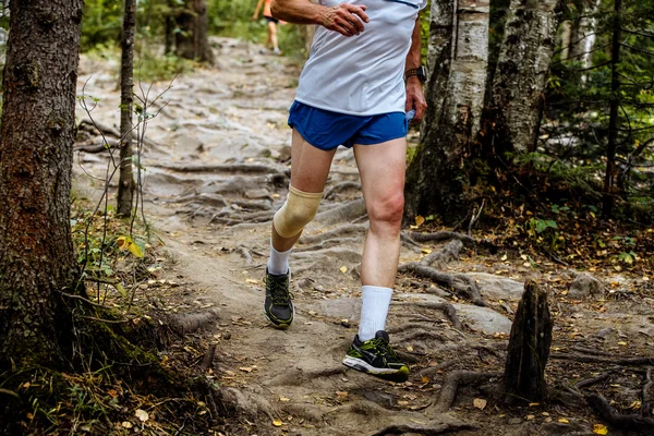 Active man running mountain marathon