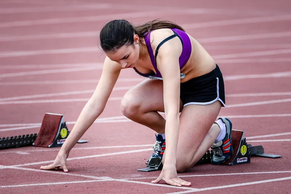 Girl  ready to start running on running track