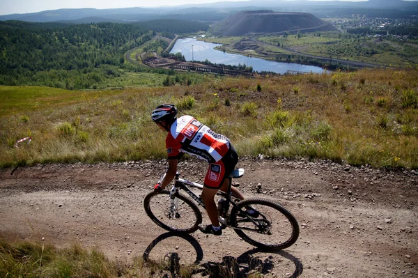 Racer mountain bike ride from the mountain