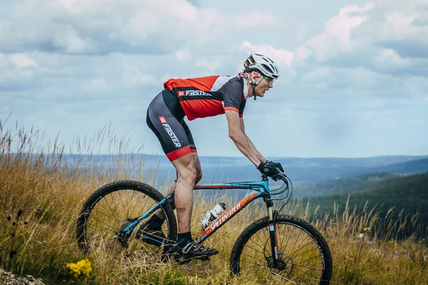 Old racer on the mountain bike downhill