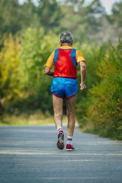 Old man athlete runs