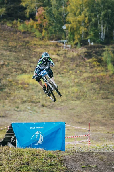 Racer on the mountain Biking jumps from a springboard