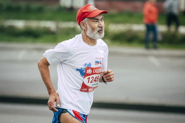 Old man runner running on street city