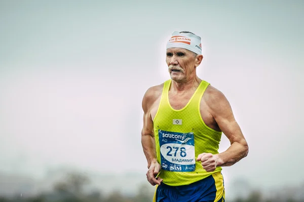 Elderly male runner running
