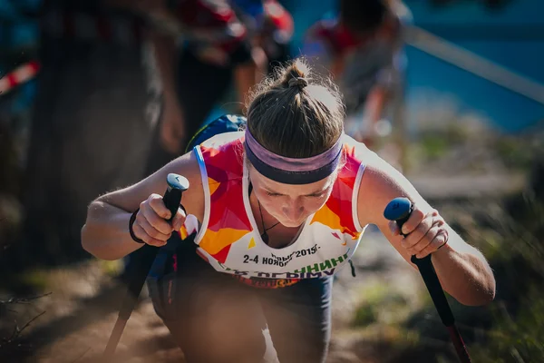 Closeup face young woman athlete with nordic walking poles