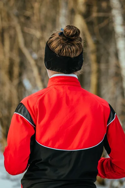 Girl running in winter forest