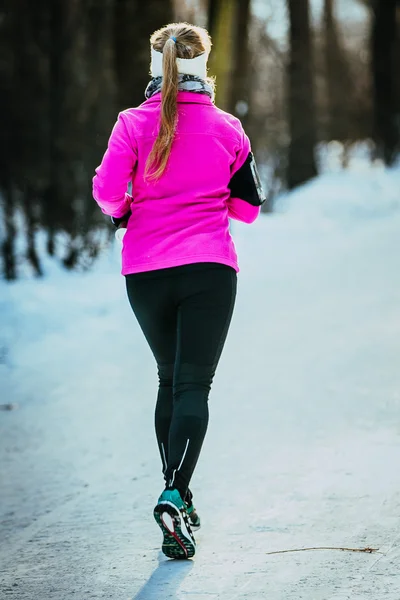 Young runner girl runs at winter Park