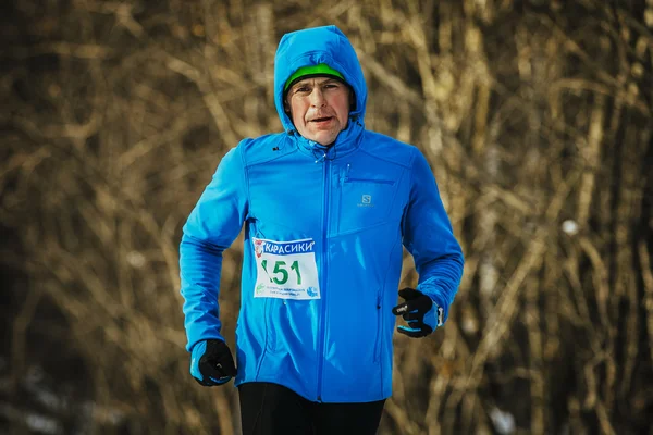 Closeup middle aged male runner dressed for winter