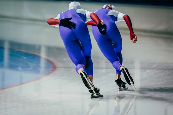 Closeup two men skaters synchronous running