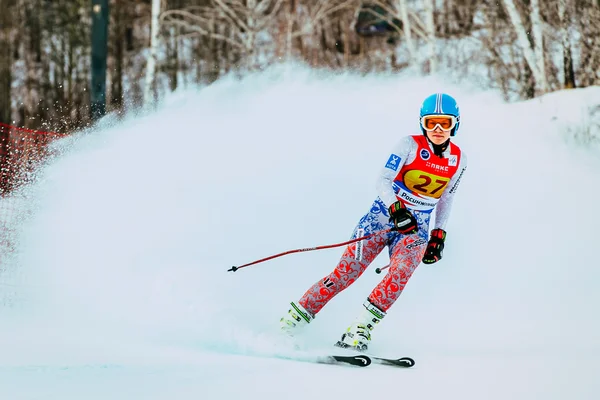 Young girl athlete after finish spray of snow during Russian Cup in alpine skiing