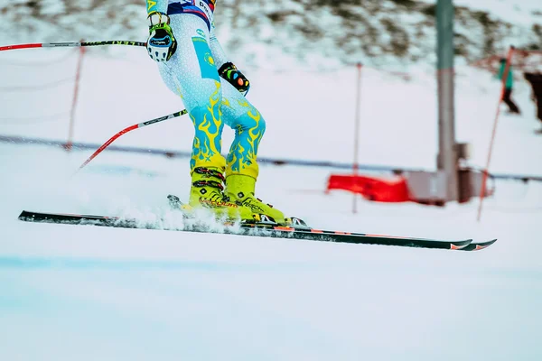 Closeup feet young girl skier after finish spray of snow during Russian Cup in alpine skiing
