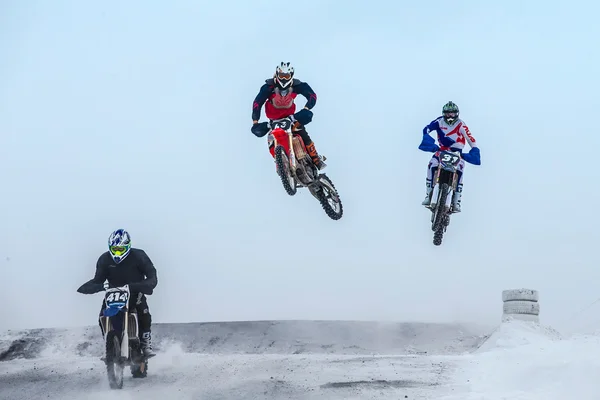 High jumps and flight riders on motorcycle at winter motocross
