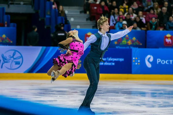 Young pair skaters on ice sports arena