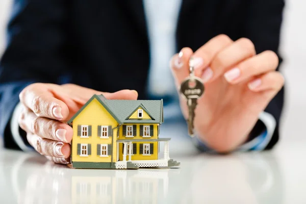 Businessman Holding House Model