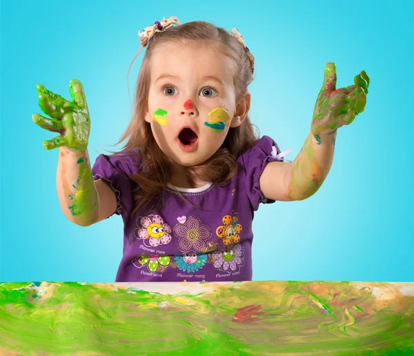 Little girl with colorful painted hands