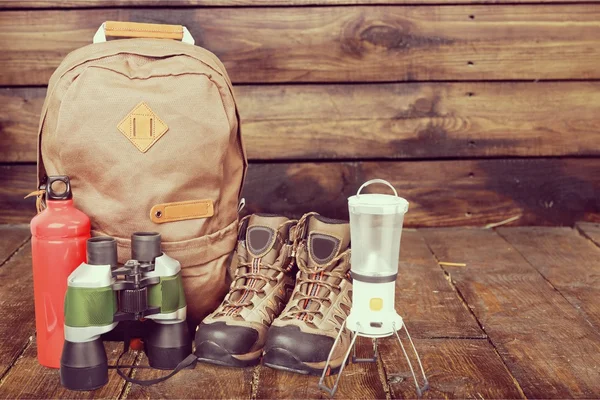 Hiking boots, backpack and map